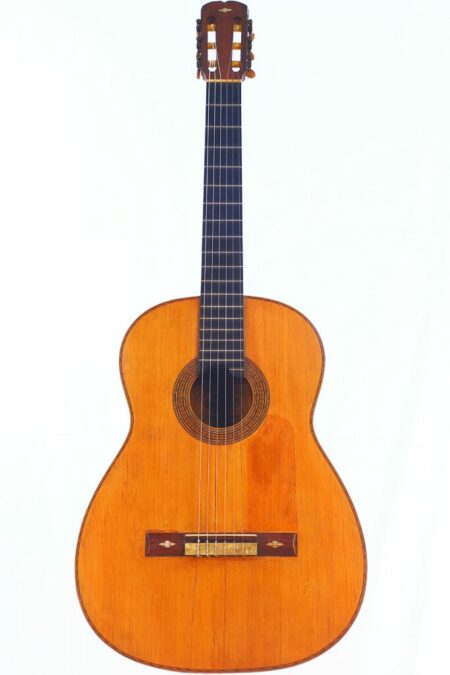 The Casa Gonzalez 1930 Flamenco Guitar features a wooden body, six strings, a dark fretboard, and a rosette around the sound hole, shown against a white background.