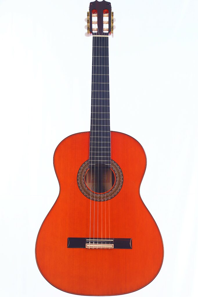 The Hermanos Conde 1999 Paco De Lucia Special Flamenco Guitar Features A Reddish-Brown Wooden Body, Dark Fingerboard, And Six Strings, Shown Against A Plain White Background.