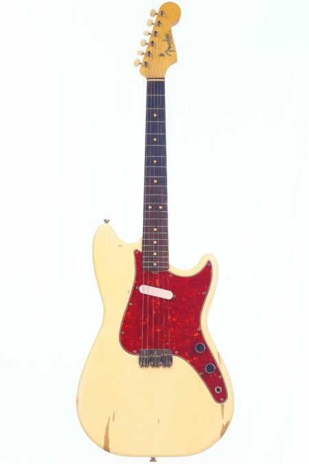 A Fender Musicmaster 1963 Electric Guitar with a cream body, worn edges, dark fretboard, and red tortoiseshell pickguard displayed on a plain white background.