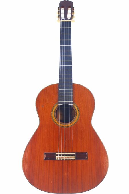 The Antonio Marin Montero 1972 Classical Guitar features a wooden body, decorative circular rosette around the sound hole, six strings, and a dark fretboard, displayed upright against a white background.