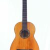 A Manuel de Soto y Solares 1900 classical guitar with a wooden body, six strings and a dark fingerboard, shown against a plain white background. A Manuel de Soto y Solares 1900 classical guitar with a wooden body, six strings and a dark fingerboard, shown against a plain white background.