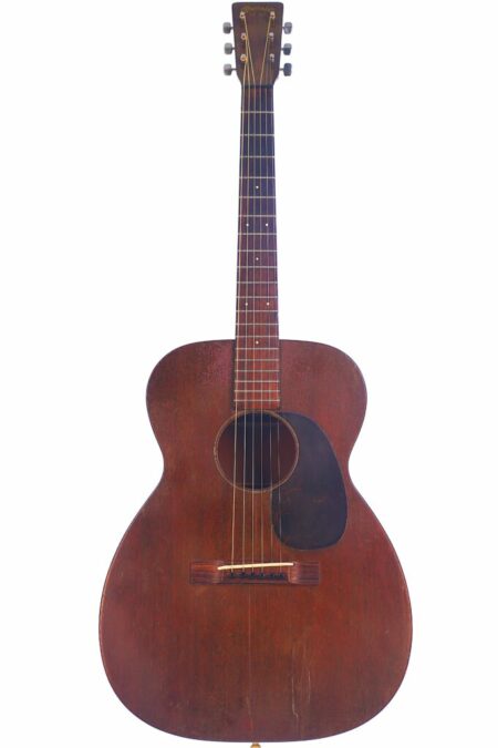 A vintage Martin 00-17 1944 Acoustic Guitar with a dark brown, rounded body, six strings, dark pickguard, and wooden bridge is shown upright against a white background.