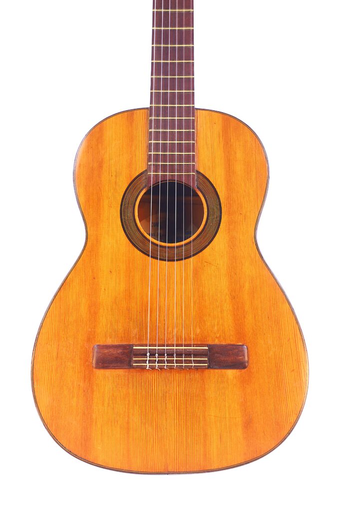The Augustin Gaspar Cebrian 1935 Classical Guitar Features A Natural Wood Finish, Six Strings, And A Round Sound Hole, Shown Against A White Background.
