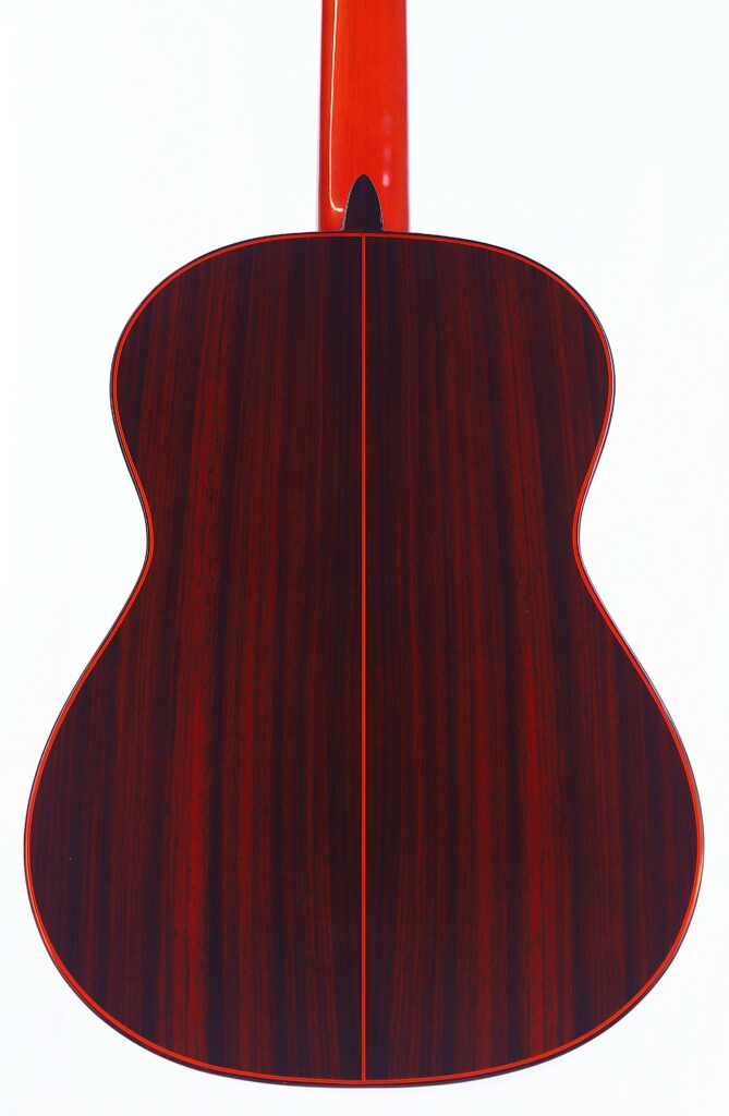 Back View Of The Hermanos Conde 1999 Paco De Lucia Special Flamenco Guitar, Featuring A Glossy Dark Wood Finish And Reddish Neck, Photographed On A White Background.