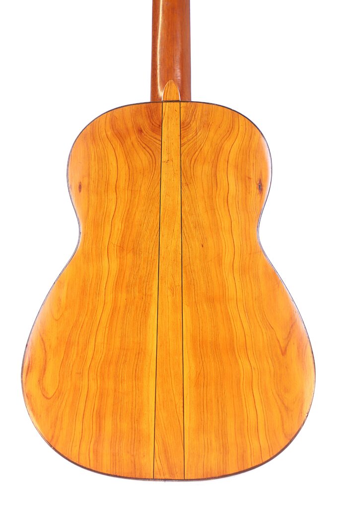 The Back Of The Augustin Gaspar Cebrian 1935 Classical Guitar Features Light-Colored Wood With Visible Natural Grain Patterns And A Central Vertical Seam.