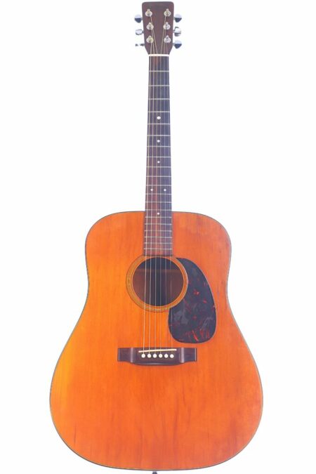 The Martin D-18 1967 Acoustic Guitar showcases a natural wood finish, dark pickguard, six strings, and silver tuning pegs, beautifully photographed against a white background.