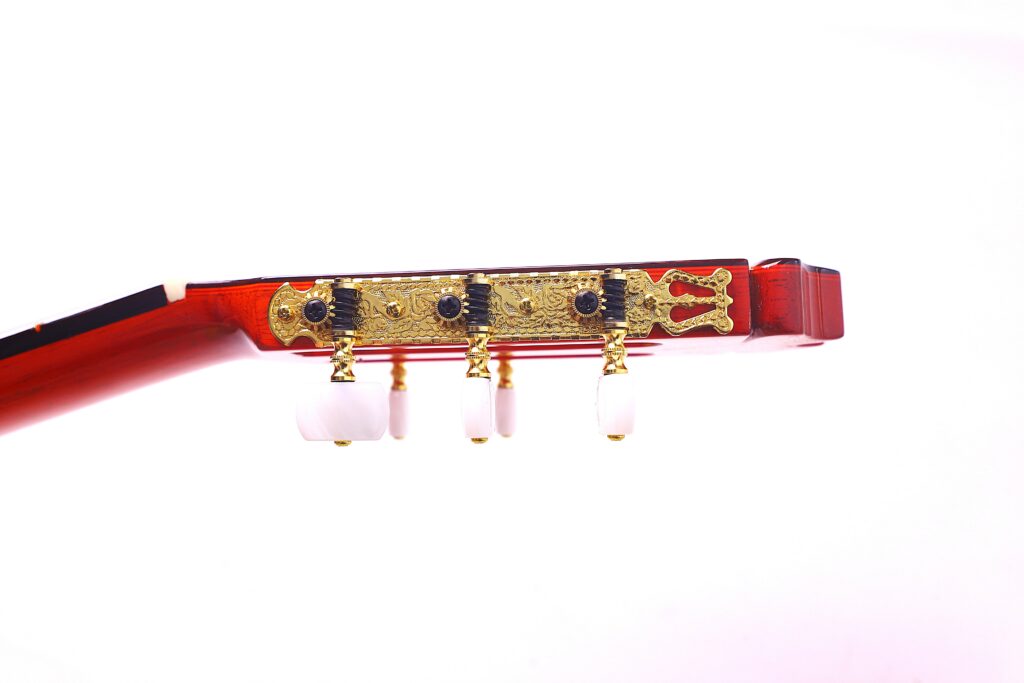 Close-Up Side View Of The Hermanos Conde 1999 Paco De Lucia Special Flamenco Guitar Headstock, Showing Ornate Gold Tuners With White Keys Against A Plain White Background.