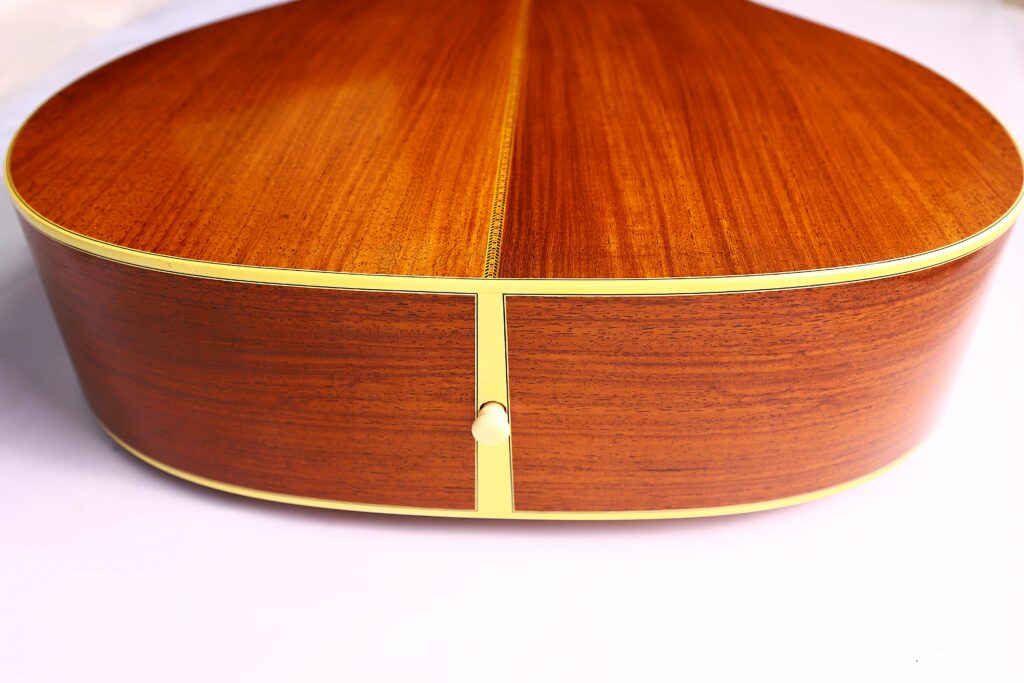 Close-Up Of The Back Of A Martin M-38 1979 Acoustic Guitar, Highlighting The Wood Grain, Decorative Center Seam, And Cream-Colored Binding Along The Edges.