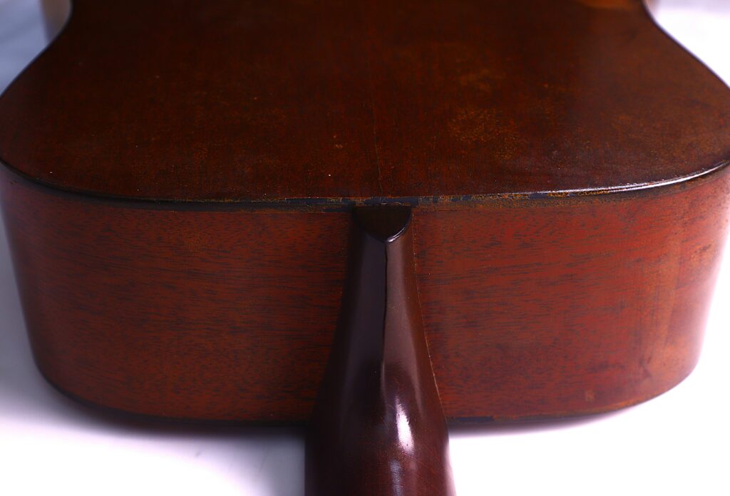 Close-Up Of The Neck Joint On A Martin D-18 1967 Acoustic Guitar, Showcasing The Smooth Brown Finish And Wood Grain Where The Neck Meets The Body.