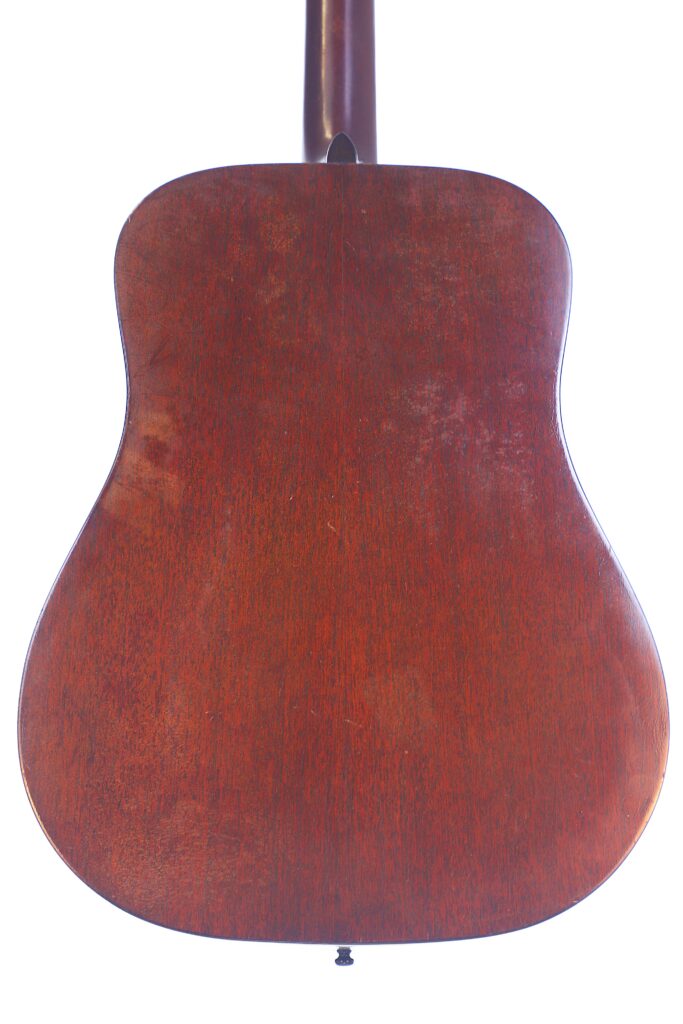 The Image Displays The Back Of A Martin D-18 1967 Acoustic Guitar, Featuring A Reddish-Brown Wooden Finish With Smooth Texture And Visible Grain, Set Against A Plain White Background.