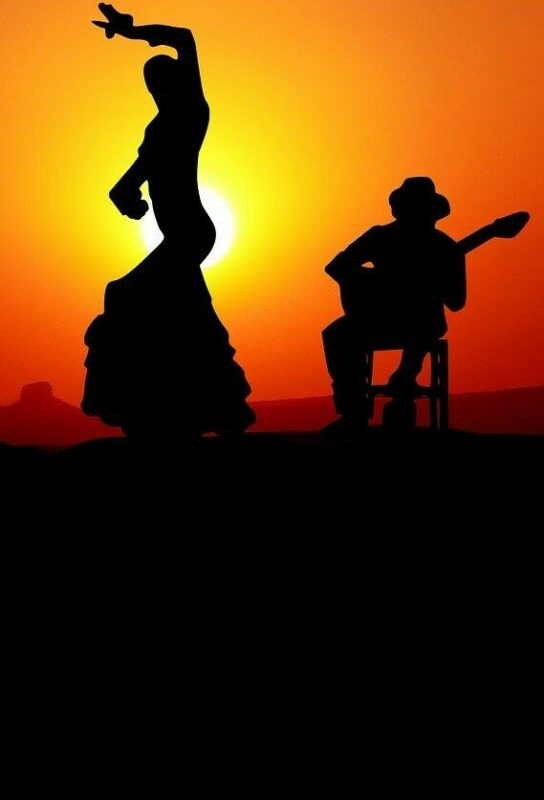 The History Of Flamenco Guitar - Silhouette Of A Flamenco Dancer With One Arm Raised And A Flamenco Guitar Player Seated Beside Her