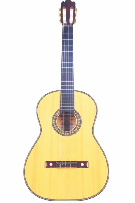 The Torres La Leona by Darren Hippner 2021 Classical Guitar features a light wood body, dark fretboard, and six strings, displayed against a white background.