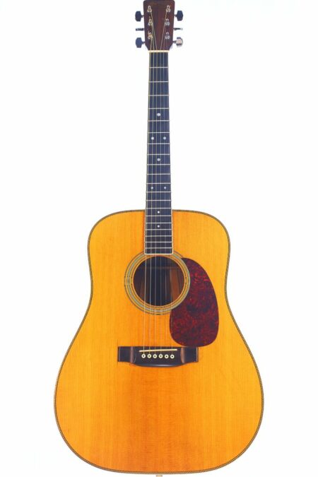 The Martin HD-35 1979 Acoustic Guitar features a natural wood finish, dark fretboard, and reddish-brown pickguard, showcased against a white background.