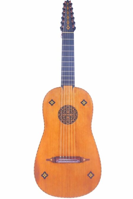 The Fernando Vera 1976 Vihuela features a light wooden body, intricate rosette, decorative inlays, and ten tuning pegs on an elongated headstock, displayed against a white background.