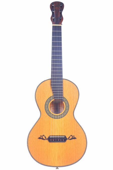 The Jesus Magdalena Martin 2021 Lacote Romantic Guitar features a light wooden body, dark fretboard, and decorative accents around the sound hole and bridge, displayed against a white background.
