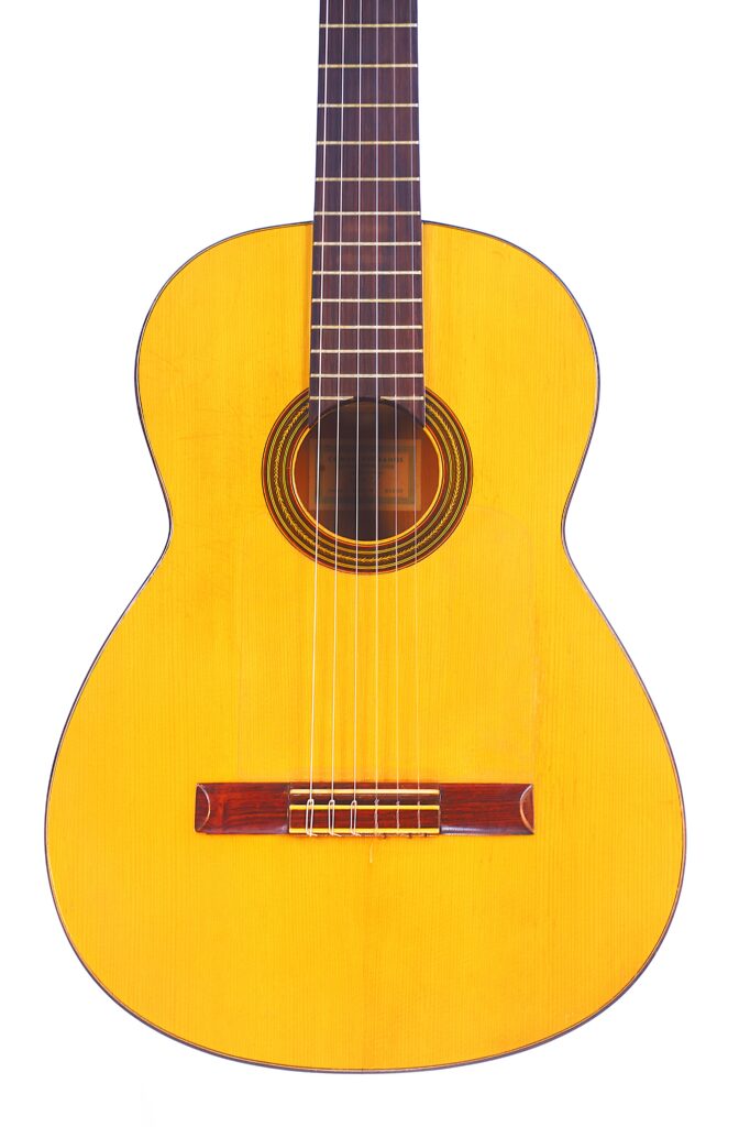 A Conde Hermanos 1971 Flamenco Guitar With A Light Wood Body, Dark Wood Fretboard, And Six Strings Is Photographed Against A White Background.