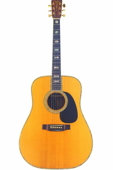 The Martin D-45 1980 Acoustic Guitar features a natural wood finish, dark fretboard with pearl inlays, gold tuning pegs, black pickguard, and decorative trim around the body and sound hole.