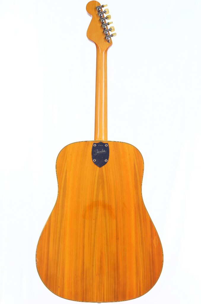 The Fender Wildwood 1967 Acoustic Guitar Is Photographed From The Back, Displaying Its Natural Wood Grain, Neck, And Tuning Pegs Against A Plain White Background.