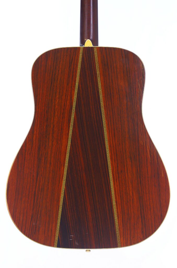 The Image Shows The Back Of A Martin Hd-35 1979 Acoustic Guitar With A Rich Reddish-Brown Wood Finish, A Distinctive Triangular Center Inlay, And Decorative Borders, Set Against A Plain White Background.
