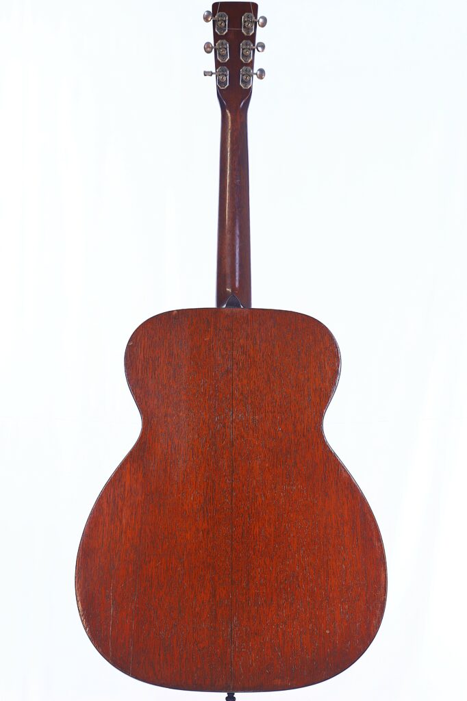 Back View Of The Martin 000-18 1950 Acoustic Guitar, Featuring A Rich Brown Wooden Finish On The Body, Neck, And Tuning Pegs, Set Against A Plain White Background.