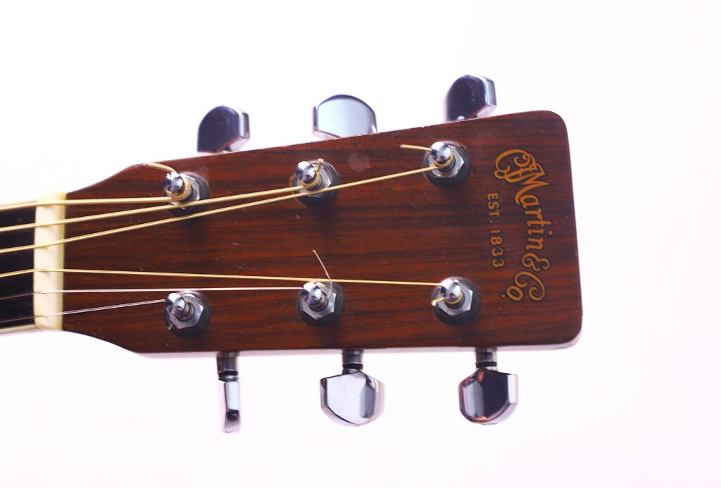 Close-Up Of A Martin Hd-35 1979 Acoustic Guitar Headstock, Featuring Six Tuning Pegs And Strings On A White Background. The Wood Displays The Martin &Amp; Co. Logo With Est. 1833 Clearly Visible.