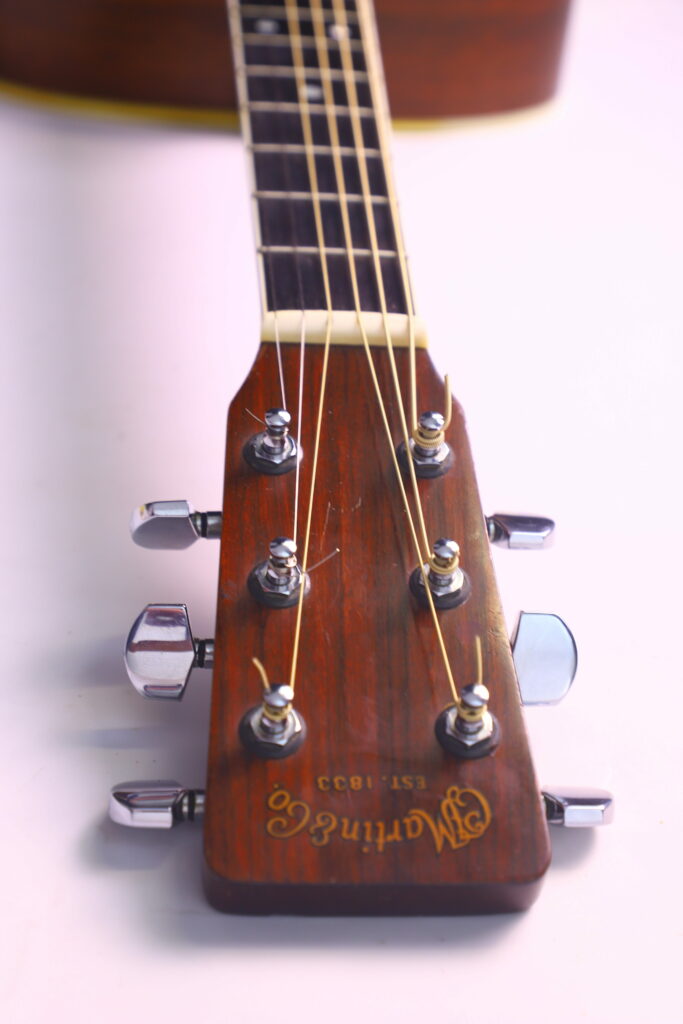 Close-Up Of The Headstock Of A Martin Hd-35 1979 Acoustic Guitar, Showing Six Tuning Pegs, Strings, And The Martin &Amp; Co. Logo On Wood, Set Against A Light Background.