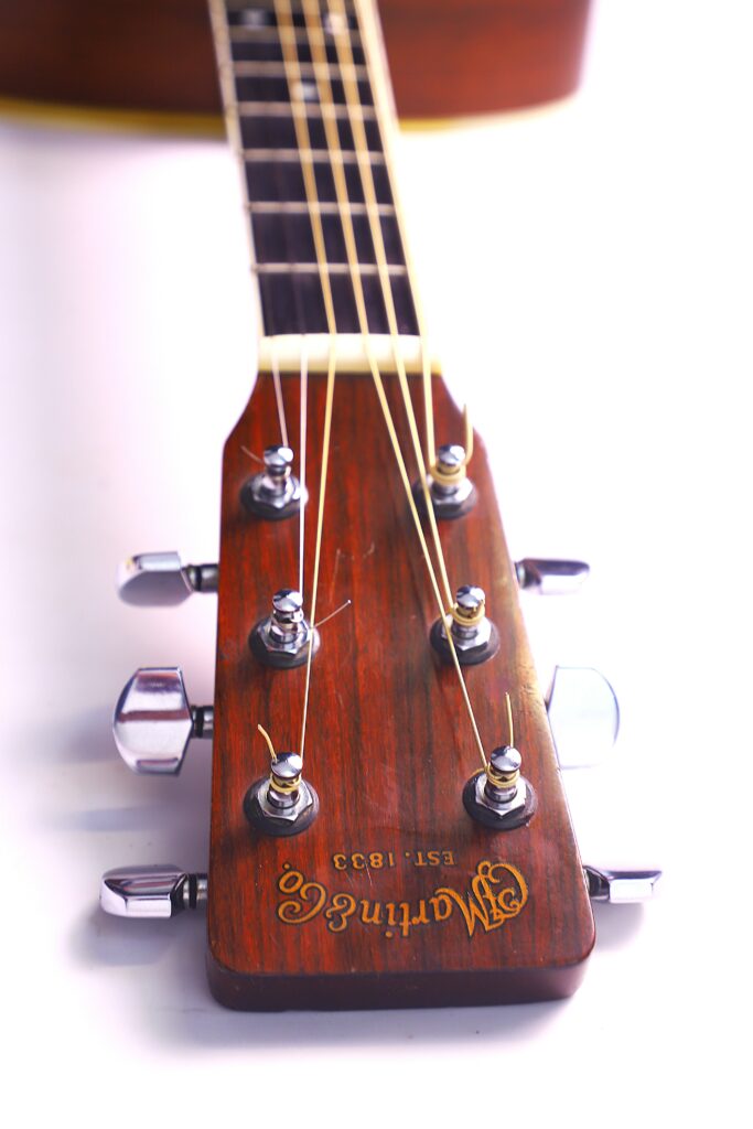 Close-Up Of A Martin Hd-35 1979 Acoustic Guitar Wooden Headstock With Metal Tuning Pegs And Strings, Photographed Against A White Background. The Martin &Amp; Co. Est. 1833 Logo Is Visible On The Headstock.