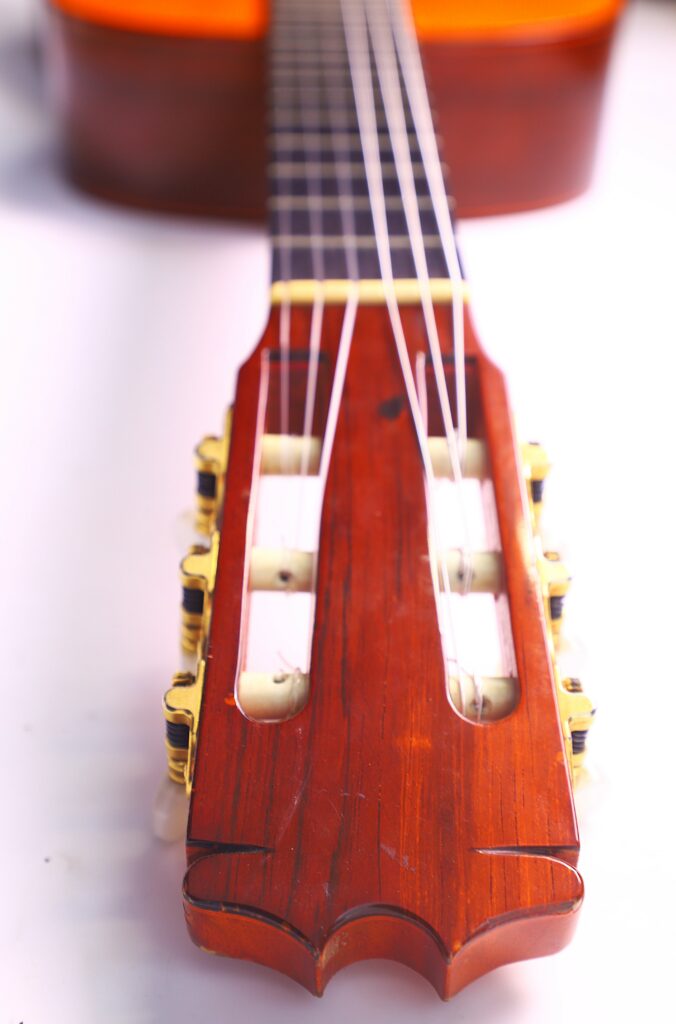 Close-Up Of The Headstock And Tuning Pegs Of A Hermanos Conde 1986 Paco De Lucia Flamenco Guitar, With Focus On The Wooden Head And Strings As The Neck Fades Out Of Focus In The Background.