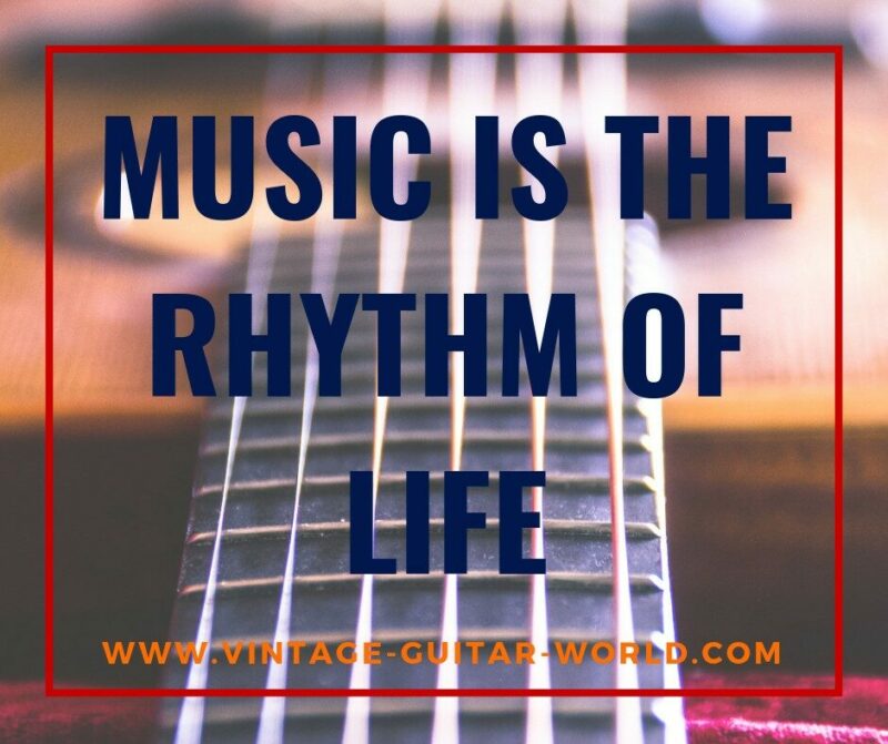 Close-Up Of Guitar Strings With The Text Music Is The Rhythm Of Life In Bold, Dark Blue Letters, And Www.vintage-Guitar-World.com In Orange At The Bottom.
