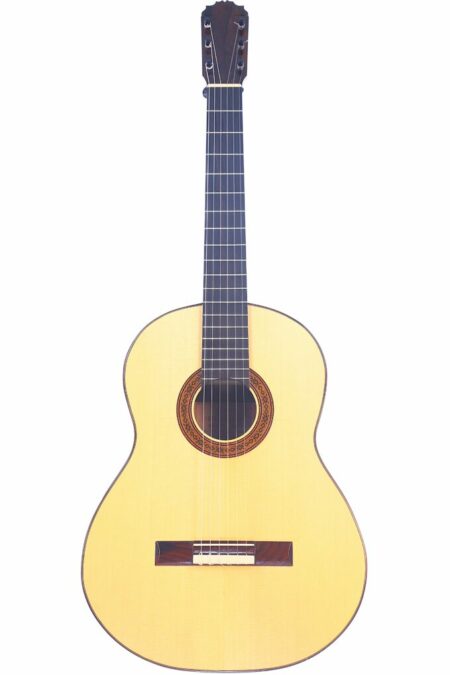 The Jose de Jesus 2024 Model Reyes Flamenco Guitar features a light wooden body, dark fretboard, and intricate rosette design around the sound hole, displayed against a white background.
