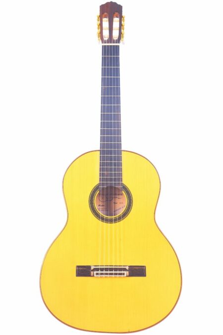 The Domingo Esteso 1935 VGW Flamenco Guitar, featuring a light wood body, dark wood neck, and six strings, is shown against a white background.