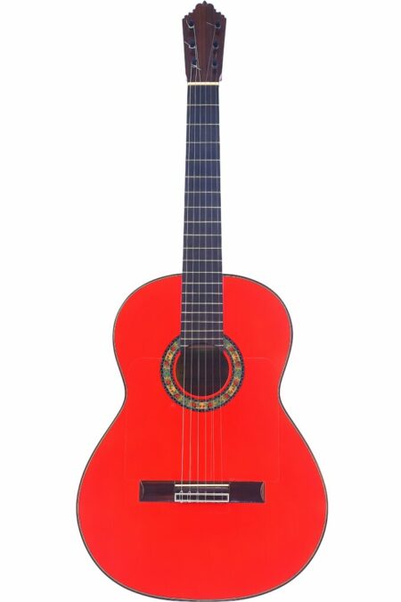 A red Pedro Fernández Luque 2021 Blanca Flamenco Guitar with a colorful rosette, six strings, and a dark wooden fretboard is shown against a white background.