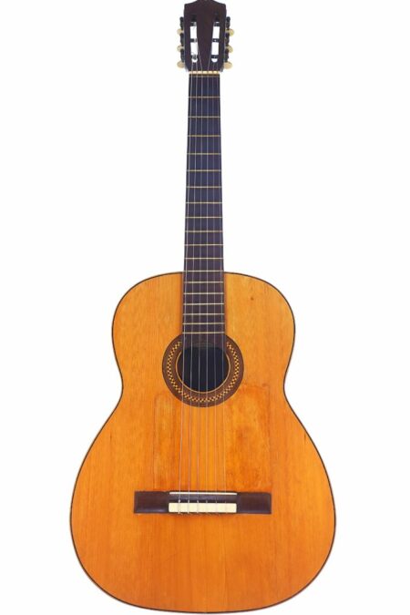 A Manuel Segura Rodriguez 1950 Classical Guitar, featuring a wooden body, dark fretboard, six strings, and a decorative rosette around the soundhole, is shown against a white background.
