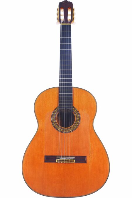 A Gerundino Fernandez 1990 Flamenco Guitar with a wooden body, six strings, dark fingerboard, and decorative soundhole rosette is displayed upright on a white background.