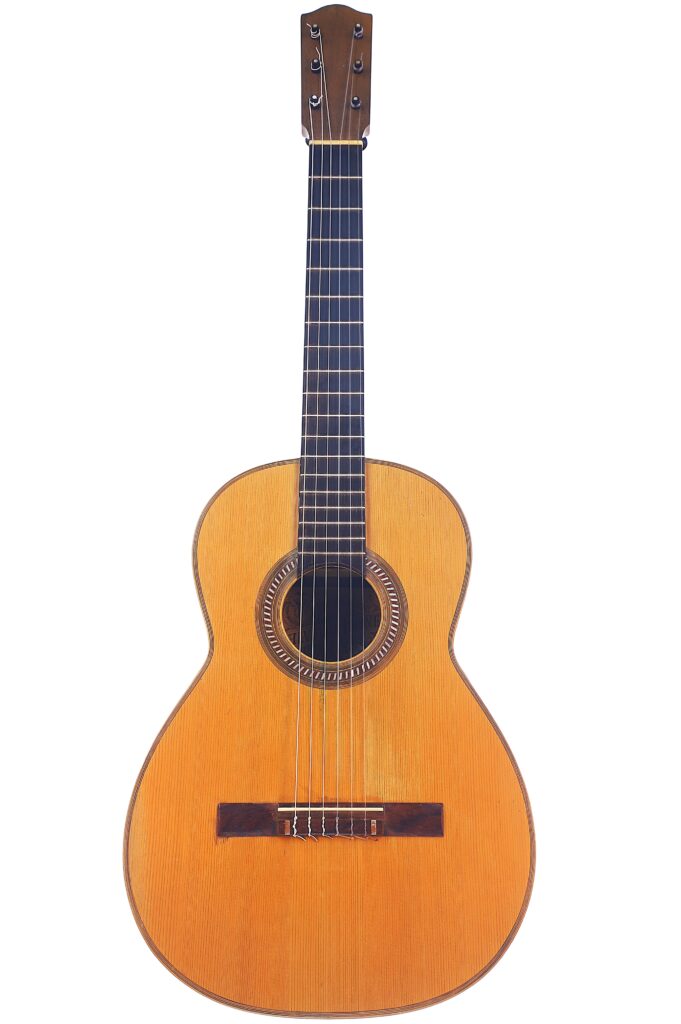 The Salvador Ibanez 1890 Classical Guitar Features A Natural Wood Finish, Six Strings, A Dark Fingerboard, And A Round Sound Hole, Displayed Against A White Background.