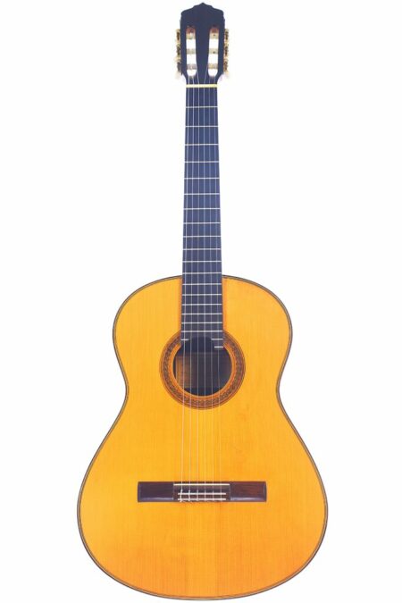The Rene Baarslag 2000 Classical Guitar features a natural wood finish, six strings, a round sound hole with decorative rosette, and a dark fretboard, shown against a white background.