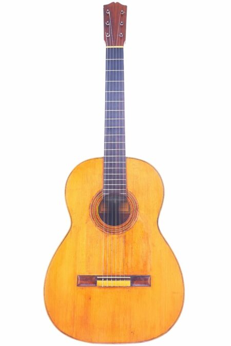 The Marcelo Barbero 1935 Flamenco Guitar features a wooden body, six strings, and a dark fingerboard, shown upright against a white background.
