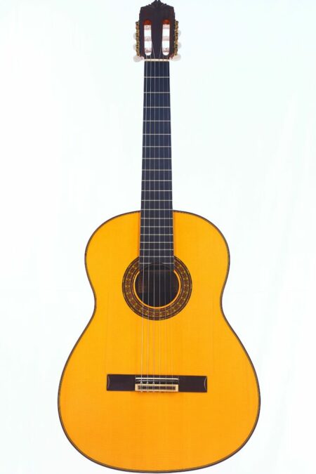 The Gerundino Fernandez 1989 Negra Flamenco Guitar features a light wood body, dark fretboard, and ornate rosette, photographed against a plain white background.