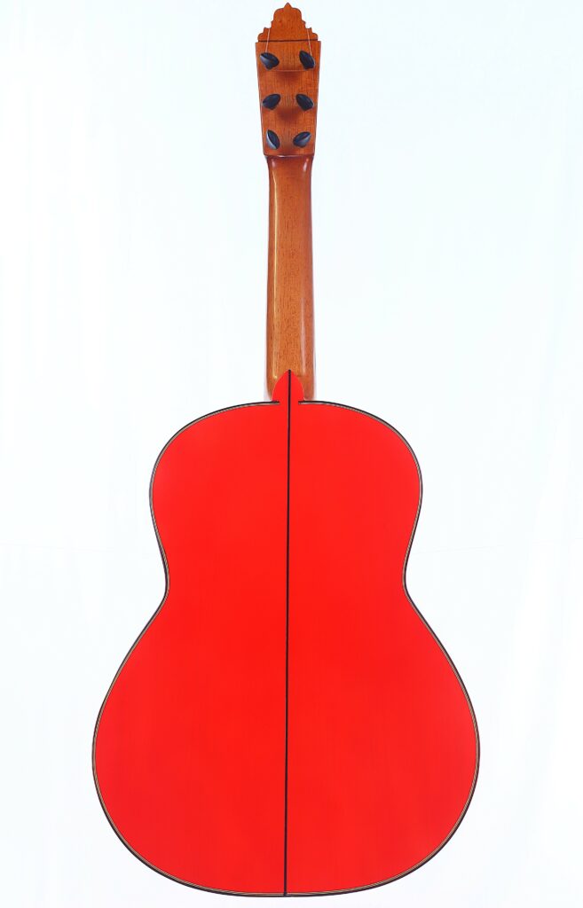 The Pedro Fernández Luque 2021 Blanca Flamenco Guitar Is Displayed From The Back, Highlighting Its Bright Red Body, Natural Wood Neck, And Black Tuning Pegs On A Plain White Background.