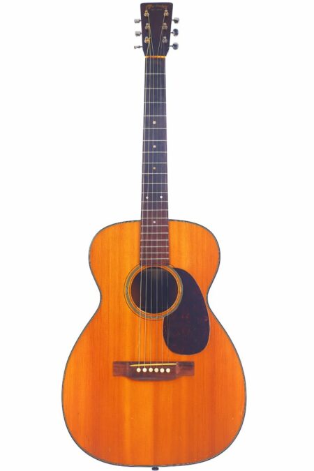 A Martin 0-18 1947 Acoustic Guitar with a classic wooden finish, six strings, dark fretboard, tortoiseshell pickguard, and white dot markers, photographed on a white background.