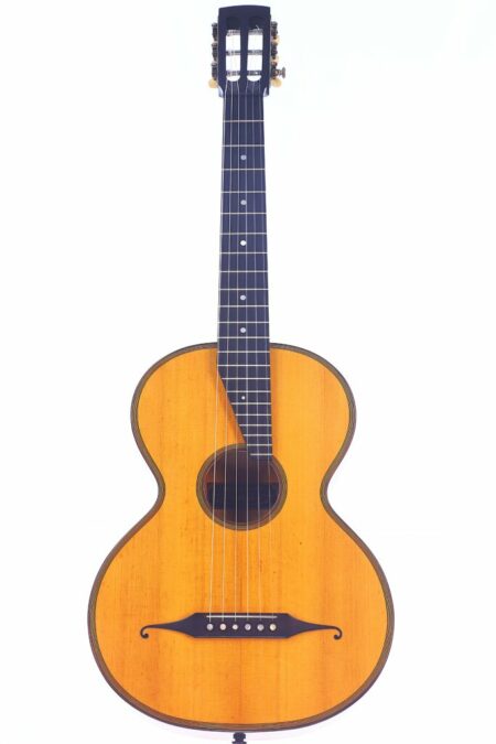 The Franz Novy 1920 Terz Classical Guitar features a light wood body, dark neck, six strings, round soundhole, and open tuning pegs. Displayed on a plain white background.