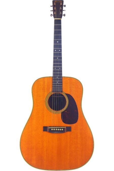 The Martin D-28 1950 Acoustic Guitar features a classic dreadnought body, natural wood finish, dark pickguard, and six strings for an elegant and timeless design.