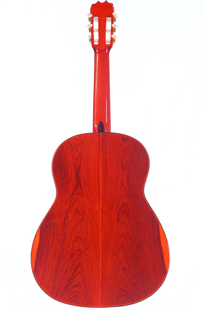 Eine Rückansicht Der Hermanos Conde 1991 Paco De Lucia Special Flamenco Gitarre, Die Ihre Glänzende, Rötlich-Braune Holzoberfläche, Sichtbare Maserungsmuster Und Klassische Flamenco-Form Zeigt.