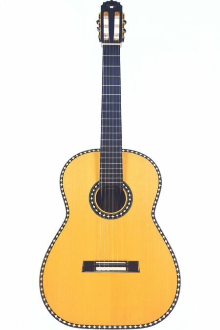 The Rafal Turkowiak 2008 Queen of Guitars Classical Guitar features a light wood body, black fretboard, and decorative black-and-white patterned edging, shown against a plain white background.