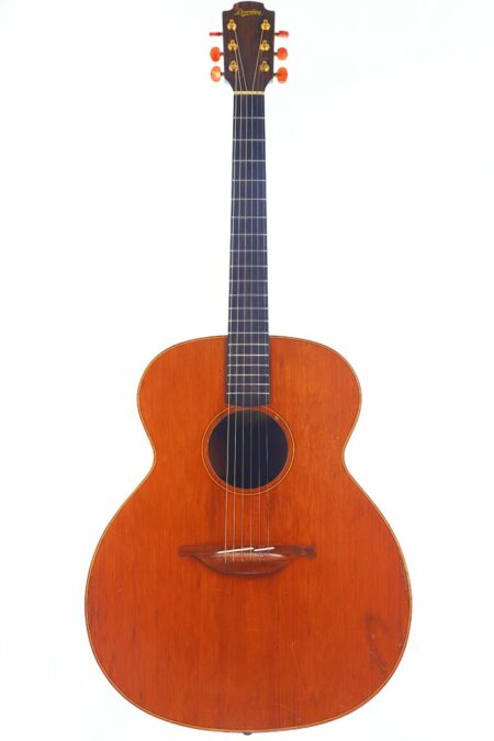 A full view of the Lowden S-10 1980s Acoustic Guitar featuring a reddish-brown wooden body, dark fingerboard, and gold tuning pegs with orange knobs, photographed against a white background.
