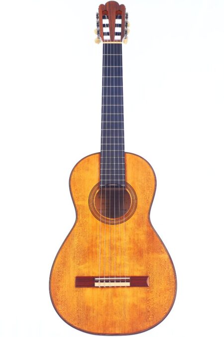 The Antonio de Torres SE77 by Jellinghaus is an acoustic guitar with a wooden body, six strings, and a dark fretboard. Tuning pegs are visible at the top, photographed against a white background.