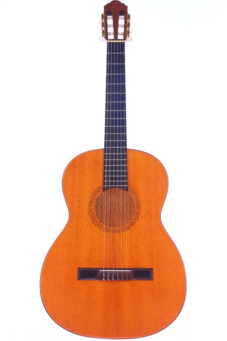 The Hopf Filigrana 1980s Classical Guitar features a wooden body, dark fretboard, and six strings, shown on a white background.