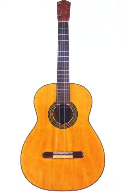 The Domingo Esteso 1934 Classical Guitar features a natural wood finish, six strings, and a dark fretboard, shown against a white background.