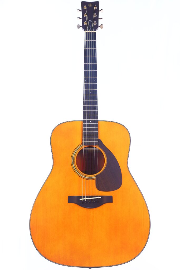 A Full-Length Image Of The Yamaha Fg5 Acoustic Guitar, Featuring A Natural Wood Finish, Dark Pickguard, Six Strings, And Black Fretboard, Photographed Against A Plain White Background.