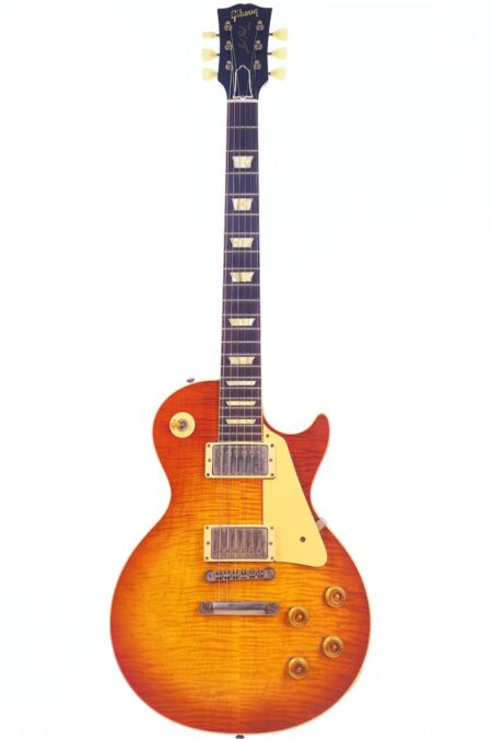 A Gibson Les Paul 1960 60th VOS Anniversary Electric Guitar with a flame maple top, sunburst finish, cream pickguard, and gold control knobs, shown against a white background.
